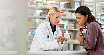 pharmacist explaining medication to patient in pharmacy discussing 5 essential tips for health