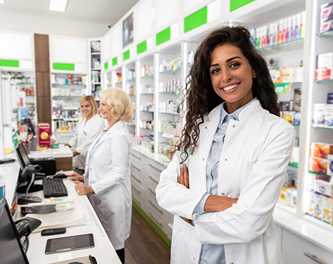 hands holding a contraceptive pill pack with seven white and maroon tablets representing a monthly cycle